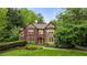 Charming Tudor home with a well-manicured lawn, mature trees, and classic architectural details at 44 Muscogee Nw Ave, Atlanta, GA 30305