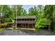 An exterior shot of a two story building, with a brown exterior, a garage, and an American flag at 44 Muscogee Nw Ave, Atlanta, GA 30305