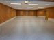 Spacious garage featuring wood paneled walls, painted trim, and a sealed aggregate floor at 44 Muscogee Nw Ave, Atlanta, GA 30305