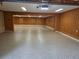 Bright garage featuring wood paneled walls, painted trim, and a sealed aggregate floor at 44 Muscogee Nw Ave, Atlanta, GA 30305