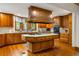 Spacious kitchen features custom wood cabinets, a large center island with gas cooktop, and upscale appliances at 44 Muscogee Nw Ave, Atlanta, GA 30305