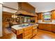 The kitchen features custom wood cabinetry, stainless steel appliances, and a center island with a gas cooktop at 44 Muscogee Nw Ave, Atlanta, GA 30305