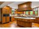 Gourmet kitchen with custom wood cabinets, stainless appliances, and a center island with a gas cooktop at 44 Muscogee Nw Ave, Atlanta, GA 30305