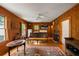 A kitchenette with wooden walls and floors, featuring a small sink, oven, fridge, and vintage decor at 44 Muscogee Nw Ave, Atlanta, GA 30305