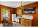 A kitchenette with wooden walls, featuring a white fridge, vintage oven and a sink with green views out the windows at 44 Muscogee Nw Ave, Atlanta, GA 30305