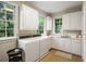 The laundry room features modern appliances, ample white cabinets, and bright natural light at 44 Muscogee Nw Ave, Atlanta, GA 30305