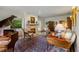 Cozy living room with a fireplace, piano, stylish furniture, and elegant decor at 44 Muscogee Nw Ave, Atlanta, GA 30305