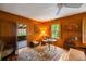 A cozy sitting room featuring wood paneling, a patterned rug, and plush seating offers a relaxing retreat at 44 Muscogee Nw Ave, Atlanta, GA 30305
