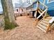 View of spacious backyard featuring wooden stairs leading to a deck above at 744 Oakland Se Ave, Atlanta, GA 30315