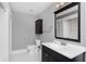 Bathroom featuring white tiled walls, shower with tub, and a dark vanity at 744 Oakland Se Ave, Atlanta, GA 30315