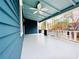 Spacious front porch with blue ceiling, white floors, and ceiling fan at 744 Oakland Se Ave, Atlanta, GA 30315