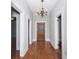 Hallway with chandelier, hardwood floors, and neutral walls at 744 Oakland Se Ave, Atlanta, GA 30315