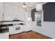 Well lit kitchen with stainless appliances, black countertops, and white cabinetry at 744 Oakland Se Ave, Atlanta, GA 30315