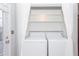 Bright laundry area with a modern washer and dryer and convenient storage shelves at 744 Oakland Se Ave, Atlanta, GA 30315