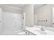 Clean, white bathroom featuring a shower and vanity with sink at 1561 Oak Ivy Ln, Lawrenceville, GA 30043
