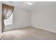 Neutral bedroom with window and neutral carpet and walls at 1561 Oak Ivy Ln, Lawrenceville, GA 30043