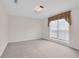 Neutral bedroom with carpet, one window, and natural light at 1561 Oak Ivy Ln, Lawrenceville, GA 30043