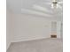 Spacious bedroom featuring tray ceiling and neutral walls and carpet at 1561 Oak Ivy Ln, Lawrenceville, GA 30043