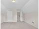 Bonus room with neutral carpet, with white walls and a door leading to another room at 1561 Oak Ivy Ln, Lawrenceville, GA 30043
