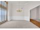 Elegant dining room with wainscoting, large window, and chandelier at 1561 Oak Ivy Ln, Lawrenceville, GA 30043