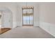 Elegant dining room with wainscoting, large window, and chandelier at 1561 Oak Ivy Ln, Lawrenceville, GA 30043