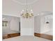 Elegant dining room with hardwood floors, chandelier, and arched entryways at 1561 Oak Ivy Ln, Lawrenceville, GA 30043