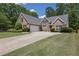Charming brick home featuring a well-manicured lawn and an extended driveway at 1561 Oak Ivy Ln, Lawrenceville, GA 30043