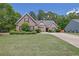 Traditional brick home with lush landscaping and a well-maintained front lawn at 1561 Oak Ivy Ln, Lawrenceville, GA 30043