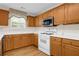 Kitchen with light wood cabinetry, white countertops, and stainless steel appliances at 1561 Oak Ivy Ln, Lawrenceville, GA 30043