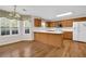 Eat-in kitchen area with wood cabinets, a breakfast bar, and hardwood floors at 1561 Oak Ivy Ln, Lawrenceville, GA 30043