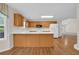 Open concept kitchen with wood cabinets, white countertops, and hardwood floors at 1561 Oak Ivy Ln, Lawrenceville, GA 30043
