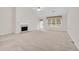 Bright living room featuring high ceilings, a fireplace, and access to the yard at 1561 Oak Ivy Ln, Lawrenceville, GA 30043
