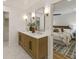 Bright bathroom with a double vanity, elegant mirrors, and marble countertops leading to a bedroom at 1860 Mountain Shadow, Stone Mountain, GA 30087