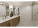 Bright bathroom with dual sinks, wood cabinetry, marble countertops, and a glass enclosed shower at 1860 Mountain Shadow, Stone Mountain, GA 30087