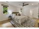 A bright bedroom features a king bed, ceiling fan, and white walls at 1860 Mountain Shadow, Stone Mountain, GA 30087