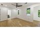 Spacious bedroom featuring hardwood floors and three windows for natural light at 1860 Mountain Shadow, Stone Mountain, GA 30087