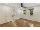 A bright bedroom featuring sleek hardwood floors, a modern ceiling fan, and serene green views from the windows at 1860 Mountain Shadow, Stone Mountain, GA 30087