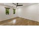 Bright bedroom with hardwood floors, ceiling fan, and view to green outdoors at 1860 Mountain Shadow, Stone Mountain, GA 30087