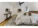 A bright bedroom features a king bed, ceiling fan, and white walls at 1860 Mountain Shadow, Stone Mountain, GA 30087