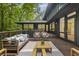 An outdoor deck featuring stylish furniture, a wood railing, and overlooking a lush, green backyard at 1860 Mountain Shadow, Stone Mountain, GA 30087