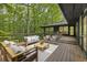 An outdoor deck featuring stylish furniture, a wood railing, and overlooking a lush, green backyard at 1860 Mountain Shadow, Stone Mountain, GA 30087