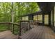 An outdoor deck with wood railing offering peaceful views of the backyard at 1860 Mountain Shadow, Stone Mountain, GA 30087