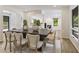Well-lit dining area with a large wooden table and access to the living room at 1860 Mountain Shadow, Stone Mountain, GA 30087
