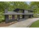 Striking contemporary two-story home featuring a dark exterior and lush surroundings at 1860 Mountain Shadow, Stone Mountain, GA 30087