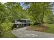 Stunning exterior view of home showcasing landscaping and mature trees at 1860 Mountain Shadow, Stone Mountain, GA 30087