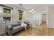 A bright hallway features wood floors, a gray chaise lounge, and skylights at 1860 Mountain Shadow, Stone Mountain, GA 30087