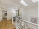 Bright hallway with hardwood floors, white railing, and skylight at 1860 Mountain Shadow, Stone Mountain, GA 30087