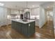 Bright kitchen features an island with white countertops, stainless steel appliances, and hardwood floors at 1860 Mountain Shadow, Stone Mountain, GA 30087