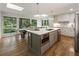 Modern kitchen featuring a large island with seating, stainless steel appliances, and natural light at 1860 Mountain Shadow, Stone Mountain, GA 30087
