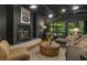 Modern living room with fireplace, large windows, and stylish decor providing a warm and inviting atmosphere at 1860 Mountain Shadow, Stone Mountain, GA 30087